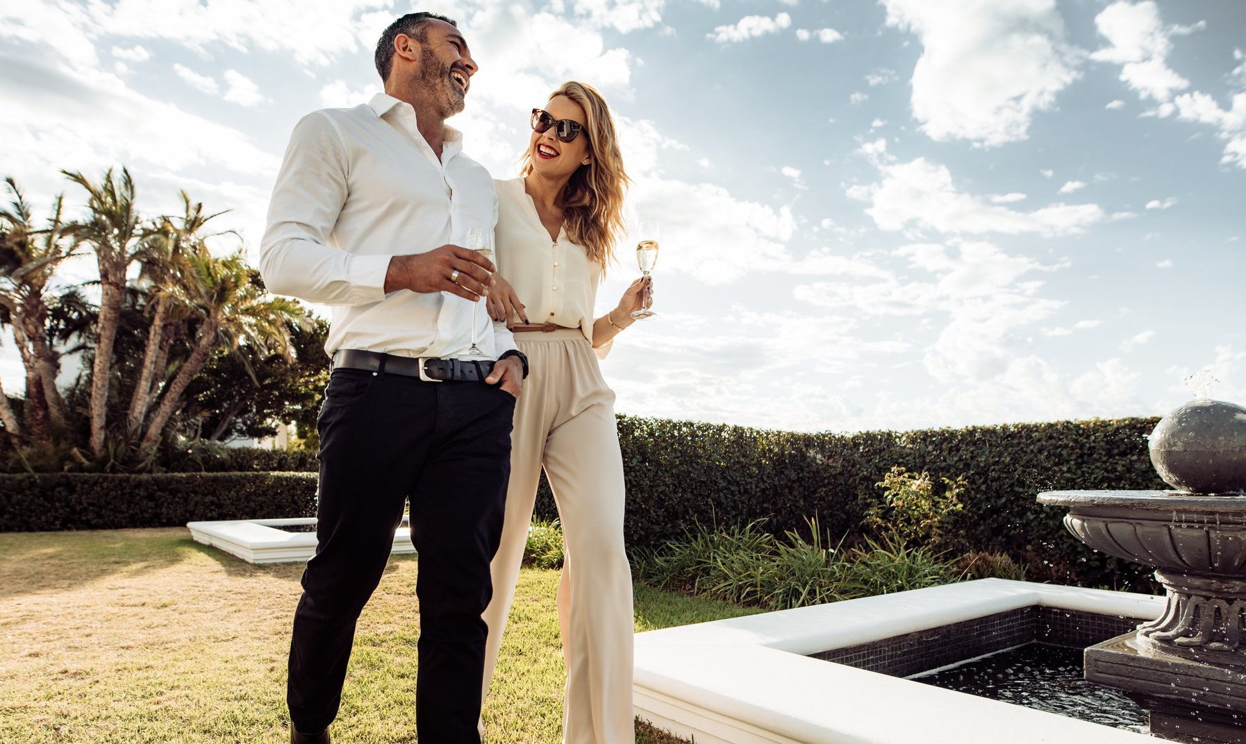 Stylish Couple Walking Outdoors and Smiling